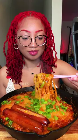 A post by @kie_eats on TikTok caption: @Buldak stew type ramen >> > is so bomb, I added green onions, sour cream and colby jack cheese! I also have jalapeño cheddar sausage  #ramen #buldak #stewtype #spicynoodles #spicyramen #asmr #mukbang #fyp #fypシ 