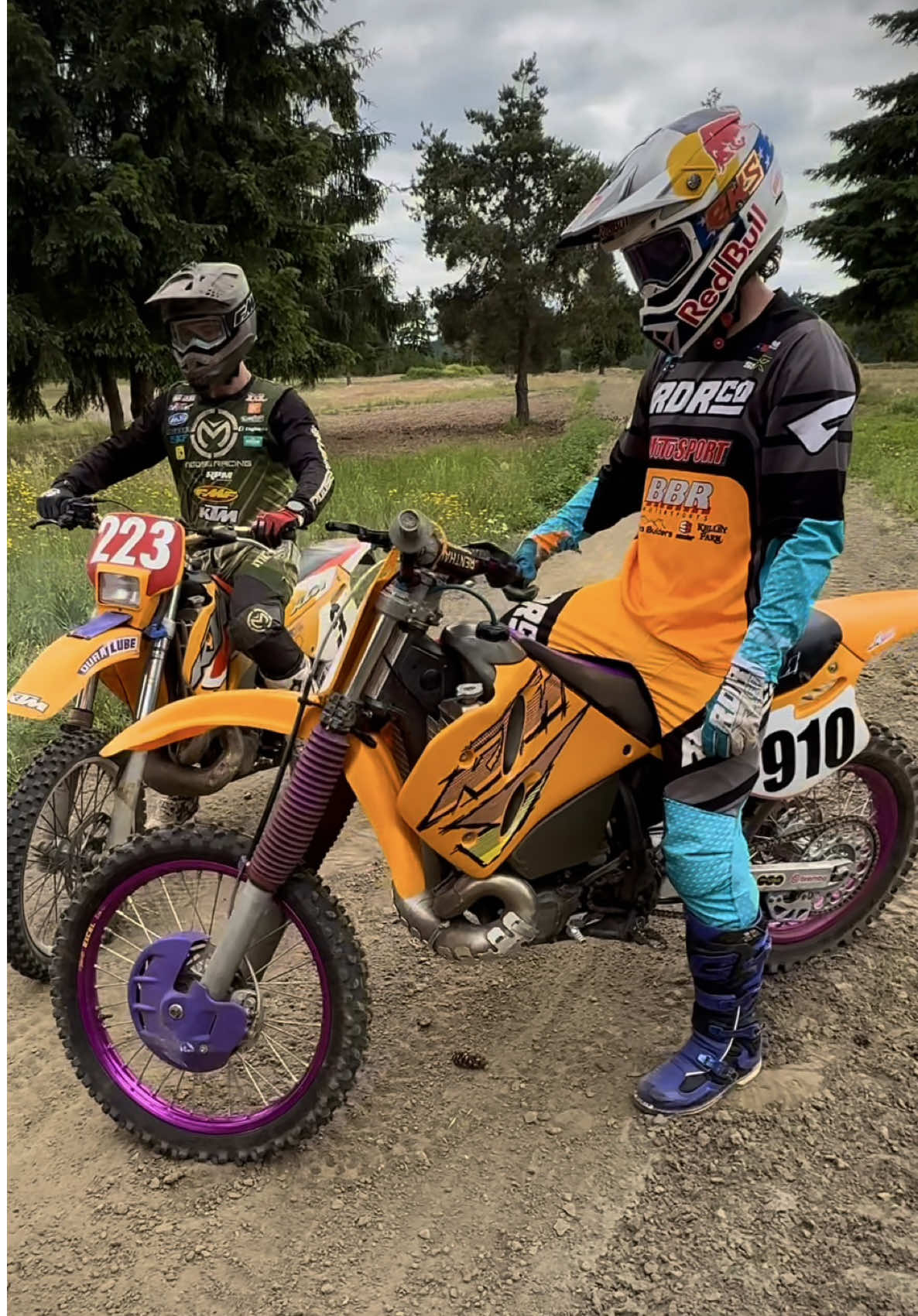 A post by @carsonbrown_910 on TikTok caption: A closer look at the machines from the last video. @lordlugnutz on his 1996 KTM 250EXC and myself on the 1996 300MXC. If you guys could bring back any KTM from the past to be made again, which model/year would you choose? @Red Bull Motorsports @Red Bull @MotoSport.com @All Balls Racing #250EXC #300MXC #KTM 🎥: @Charlie McDermott Hale 