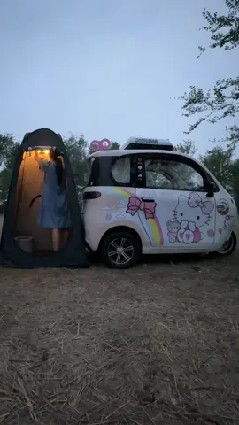 A post by @ellaonwheels_0 on TikTok caption: On the rest day, I drove my tricycle to camp in the wild, hoping it would rain today.Because I like to stay in the car and listen to the rain.🌧️ #tricycle #minicar #electriccar #campinglife #limousine#outdoors #relax #happy #fyp 