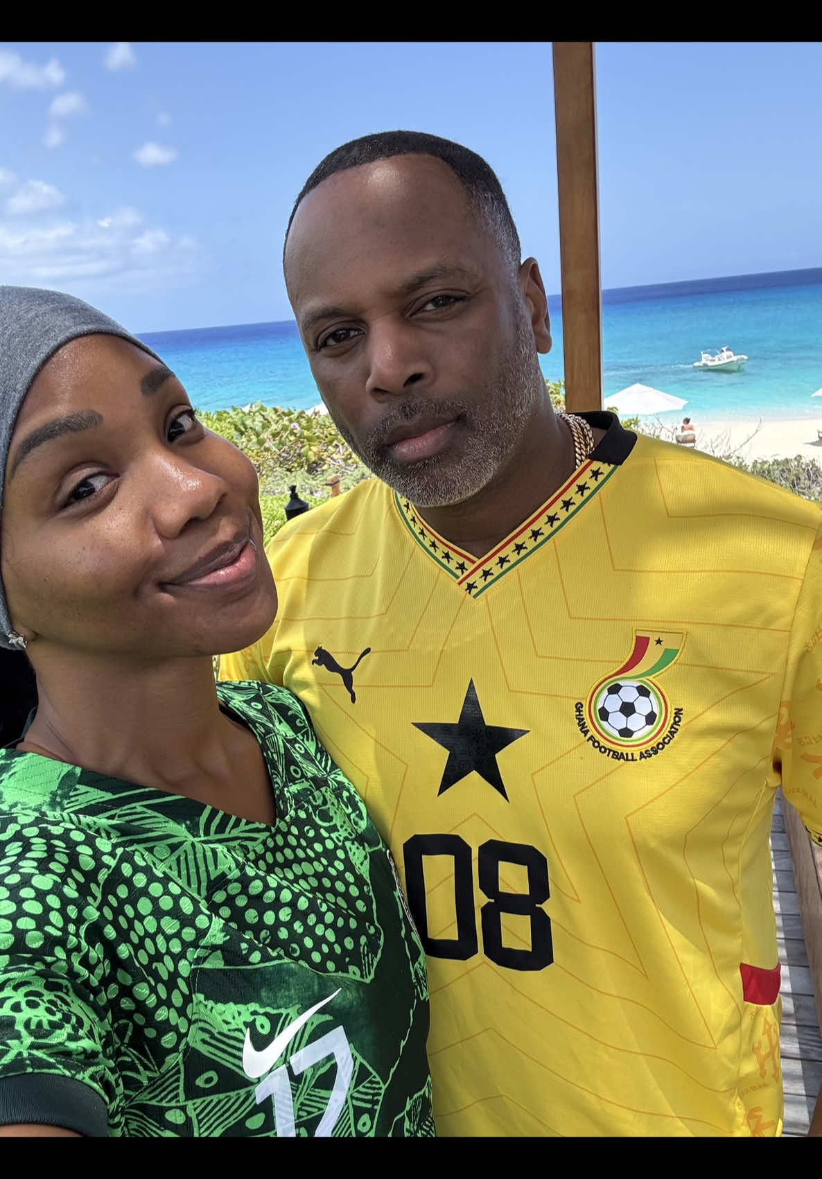 A post by @realsarahjakesroberts on TikTok caption: Last week on vacation we got dressed to work out and realized we were both repping the continent. 🇳🇬 ❤️ 🇬🇭  Also, in an interesting turn of event, after 10 years of marriage  I’ve decided to randomly start slapping and grabbing.  Tables are turning. No buns are safe 😂