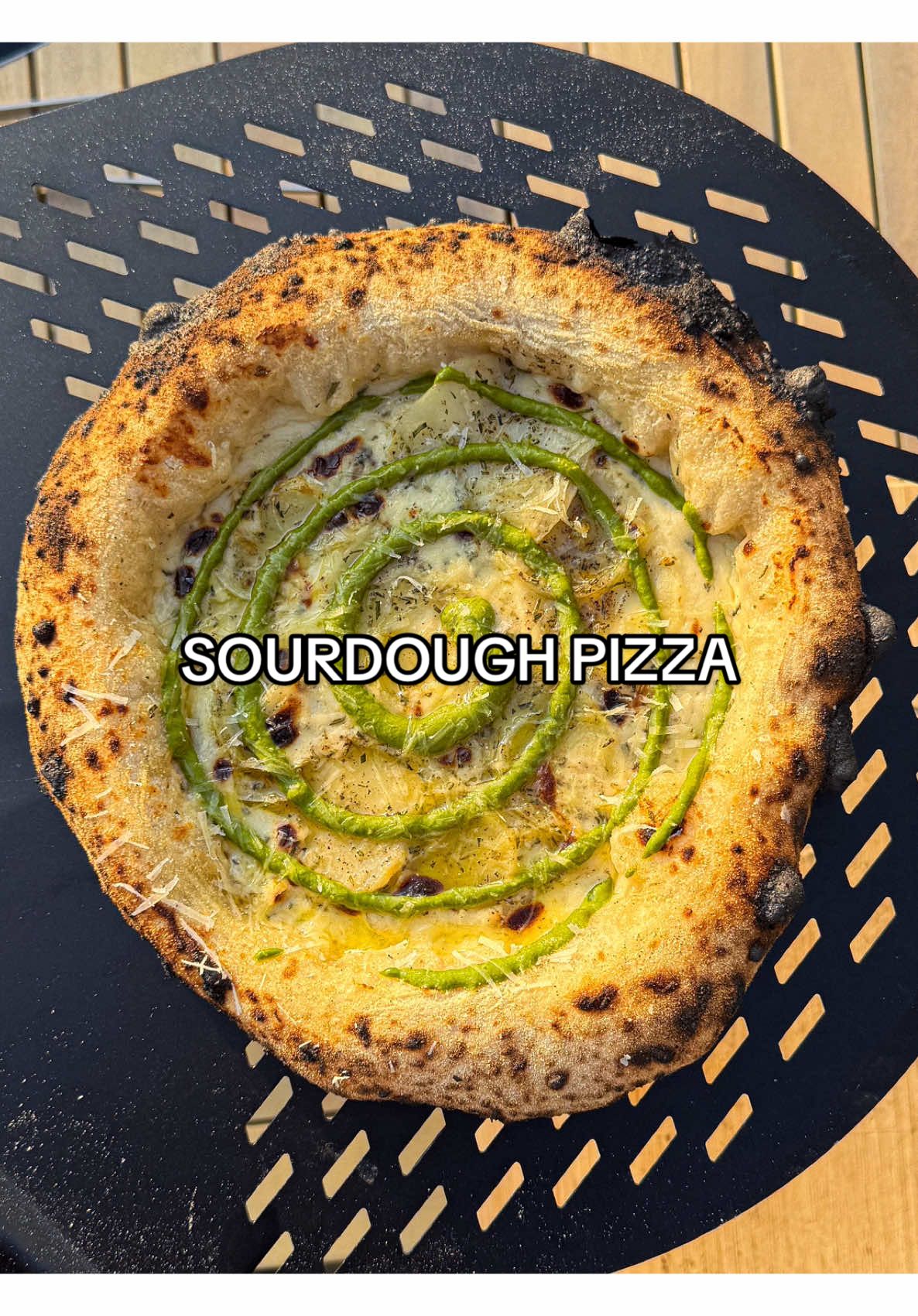 A post by @samseats on TikTok caption: Sourdough Pizza 🍕 White based bechamel pizza with a silky smooth pesto 🔥 Full recipe up on my Substack, link in bio! #Pizza #asmr #cooking #summer 