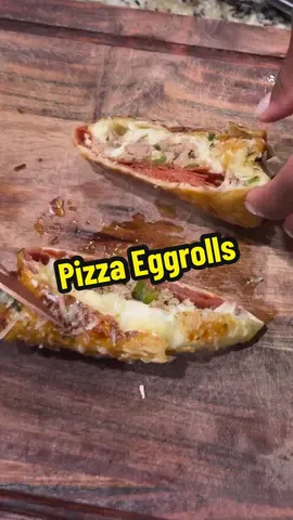 A post by @blackfoodiefinder on TikTok caption: Pizza Eggrolls 🍕(via @clubbkitchenbykiaj)  Drenched in garlic butter and freshly grated Parmigiano-Reggiano then dipped in pizza sauce 😋 #BlackFoodieFinder #eggrolls #pizzarecipe #easyrecipe #dinnerideas #dinnerinspo 