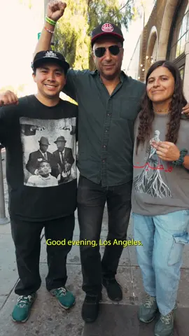 A post by @theneighborhoodkidsmusic on TikTok caption: "My new favorite band, The Neighborhood Kids" - @Tom Morello  Was an absolute honor to be invited and introduced by Tom, Defend LA was a historical event and we are glad we were able to be a part of it. The fight against ICE and our oppressors doesn't stop here it only continues. Keep resisting the powers that be and fight for your neighbors and community's safety ✊🏽 Filmed by: @Fern_doe #undergroundhiphop #livebands #theneighborhoodkids #defendla #tommorello #liveshow #hiphopmusic #althiphop #raptok #numetal #altrap 