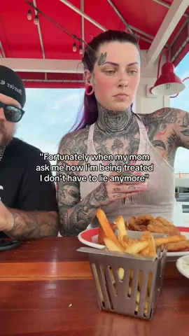 A post by @miss.spider.legs on TikTok caption: He always shares his crab legs with me 🥰 I got fish 🐟 #spiderlegs #yallternative #tattooedbrows #biker #relationshipgoals #fypシ #foryoupage #happycouple 