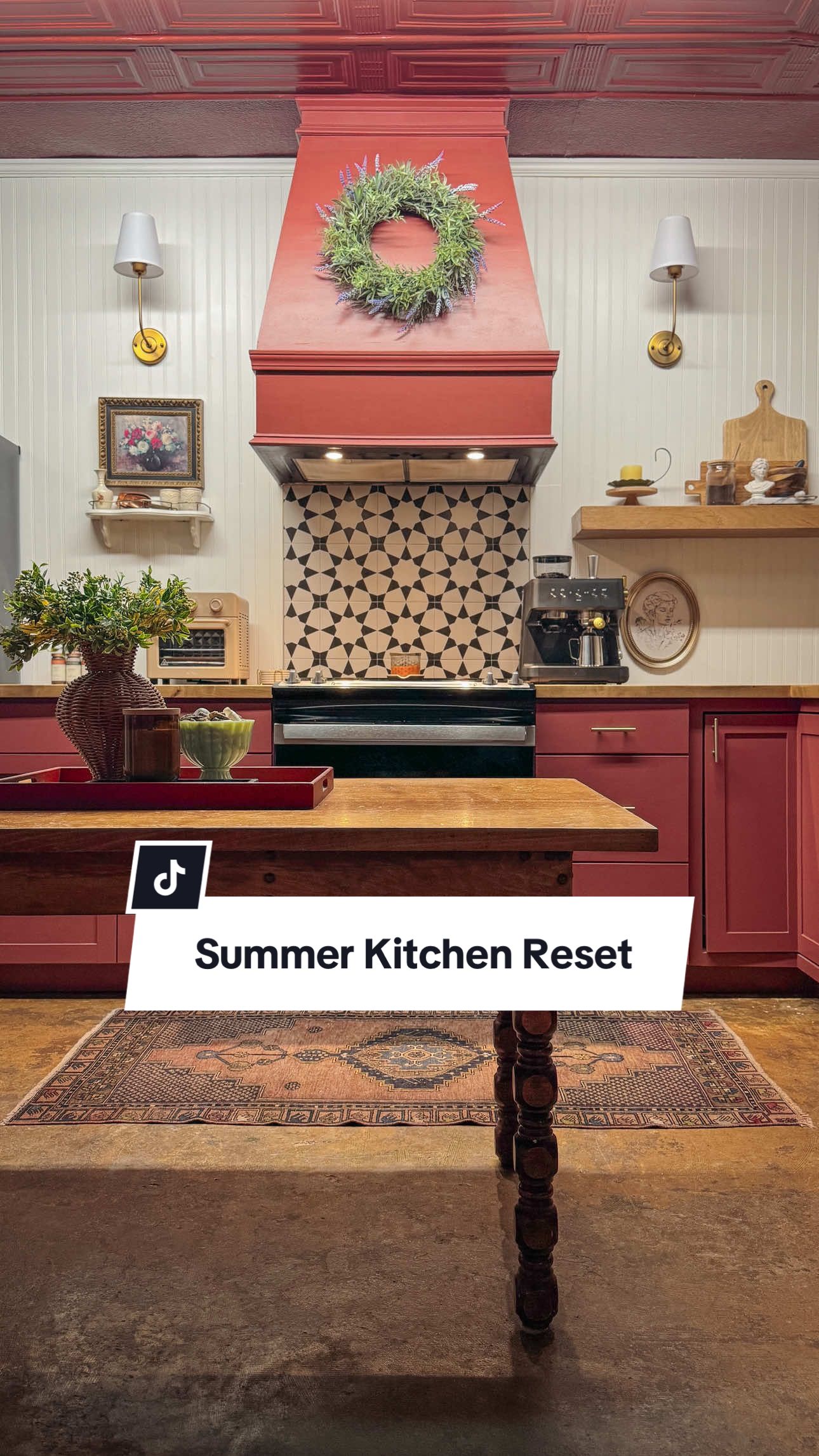 A post by @thecolorofourhome on TikTok caption: Summer kitchen refresh is officially served. ☀️🍓 Gave the kitchen a little summer love this week—deep cleaned every corner, swapped in fresh decor, and added some seasonal touches. 💐🧼 The lavender wreath, vintage artwork, pottery, and greenery made all the difference. It feels cozy, clean, and totally refreshed! Now all that’s missing is something sweet baking in the oven. 🥧✨ #KitchenRefresh #VintageStyle #CottageCoreKitchen #SummerVibes #SummerReset 