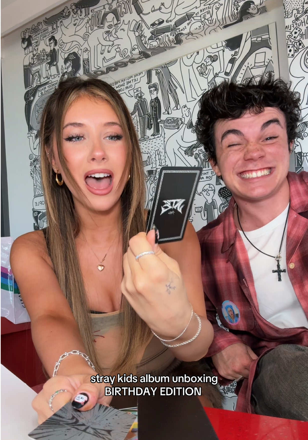 A post by @ellianawalmsley on TikTok caption: unbox another @Stray Kids album with us because it was my birthday LOLL @Jentzen Ramirez 😝😝 these are so chaotic #fyp #foryou #jelliana #straykids #kpop #kpopalbum #albumunboxing #kpopalbumunboxing #couple #funny 