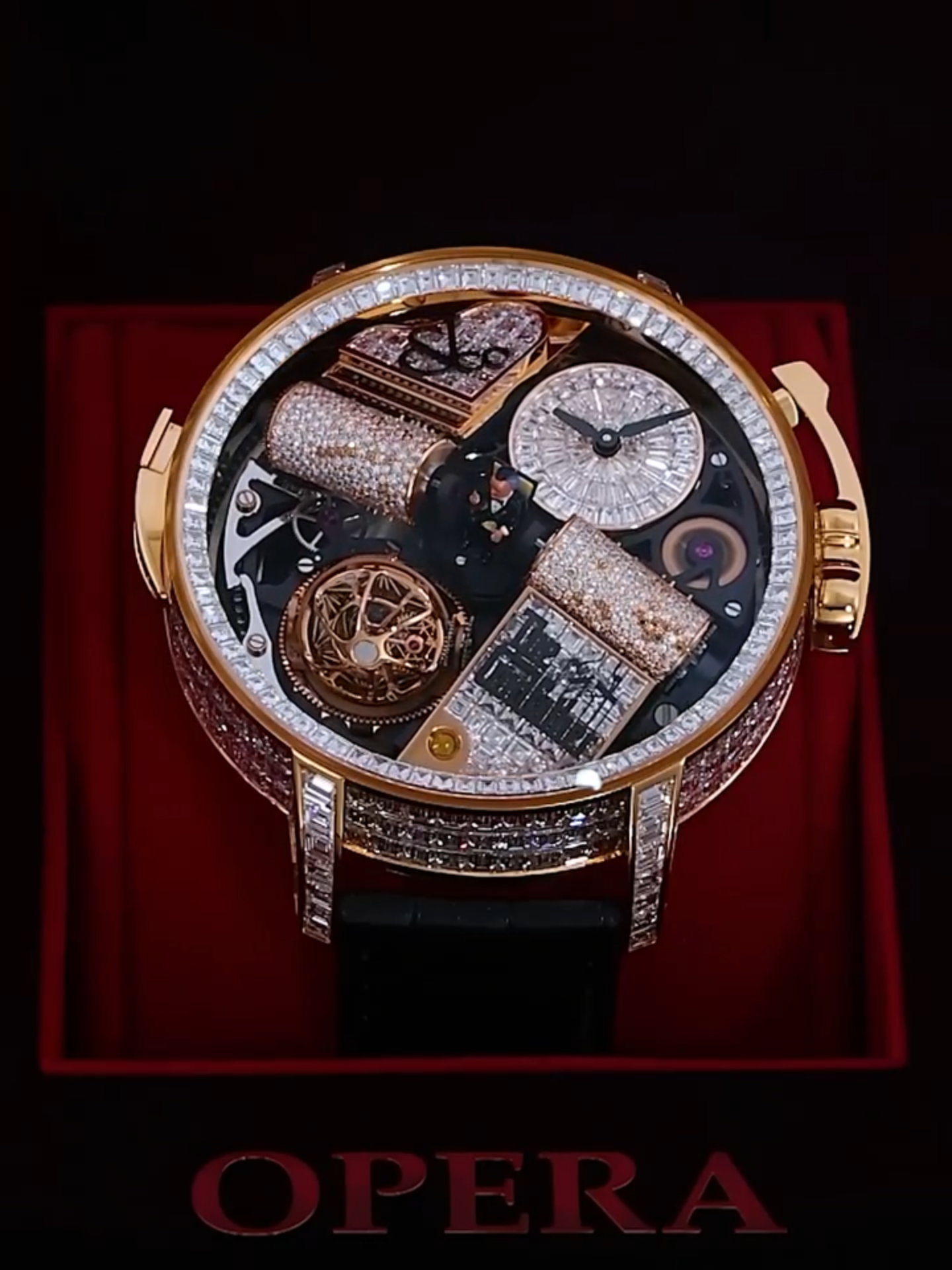 A post by @jacobandco on TikTok caption: The curtain opens on Opera Godfather Baguette. The unique piece is set with diamonds throughout. On the lugs, front and sides. On the caseband, and the violin-shaped crank. On the decorative plate symmetrical to the iconic piano. On the round hour and minute dial. All the way down to its music box cylinders. #InspiredByTheImpossible #jacobandco #Canelo #thegodfather