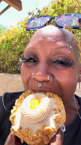 A post by @beauty2thestreetz on TikTok caption: I stopped by today and the Peach Cobbler donut is flying off the shelves! 🙏🏿🙏🏿 you guys make sure you stop by this weekend and grab a doughnut. Leave one for the homeless community as well. Pay forward. @ilovesainthonore you can also donate a donut online