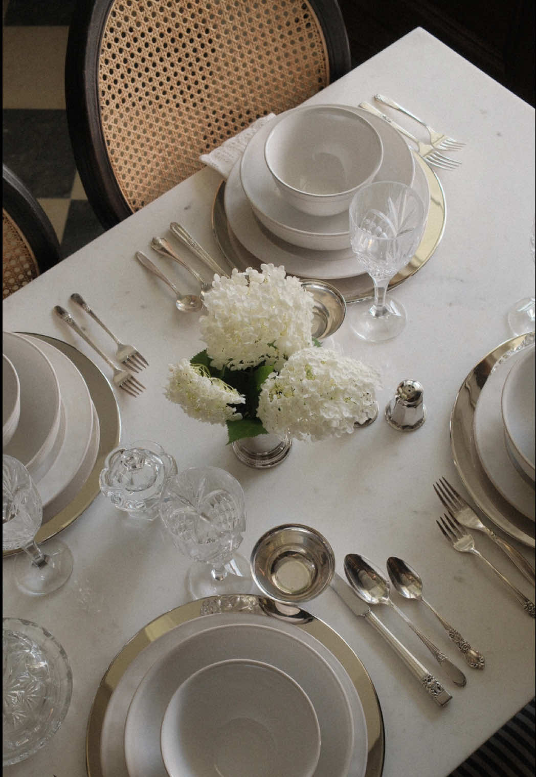 A post by @peonyandhoney on TikTok caption: Comment DINE for links!  @potterybarn sent me some exquisite serveware pieces for our dining room, and even though it isn’t quite finished yet, I just had to set the table!  I wanted pieces that would feel classic and go with any future theme I might use for a dinner party!  I also incorporated some vintage pieces like the crystal glasses, butter dish, and my silverware are mismatched silver vintage sets from Pottery Barn, which I feel is such a special touch.  I absolutely cannot wait to host a dinner party here!  #mypotterybarn #dinnerparty #dinnerpartyideas #setthetable #tablesettings #tablescapestyling #gifted  @@peonyandhoney DIY + Home 