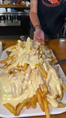 A post by @iluvceomomotion on TikTok caption: THE BOARS NEST 10 LB POUTINE CHALLENGE😋#food #foodchallenge #hungry #foodchallenge #live #liveforthechallenge #foodchallenges #travel #Omw #frenchfries #poutine #meat #cheese #fries #illinois #missouri #fyp 