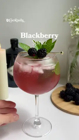 A post by @cocktails on TikTok caption: Happily adding a blackberry spritz to our list of summer essentials. 💜🌿 Ingredients: - 1/2 oz. lime juice - 4-5 mint leaves - 1 & 1/2 oz. gin - 1/4 oz. honey - 1/2 oz. blackberry simple syrup (used Monin) - 3 oz. prosecco - 2 oz. club soda #blackberry #spritz #cocktail #mint #blackberryspritz #berry #summer #drink #inspo