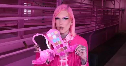 A post by @jeffreestar on TikTok caption: HOWDY! How are ya? 🤠 It's OFFICIAL the most anticipated collection of the summer…! Meet our #ICONIC Cowgirl Queen Collection! Time to get rowdy! Inspired by my pink ranch life out here in Casper, Wyoming living on the Star Yak Ranch! This collection includes the first-ever cowgirl boot shaped artistry palette, 7 new Shiny Trap Lipstick shades, 2 BOLD BeachProof Mascara shades, 2 PINK Lip Oils, #ICONIC accessories and merch to embody the cowgirl spirit.  The ENTIRE Cowgirl Queen Collection LAUNCHES Friday, July 11th at 10am PST / 1pm EST! #jeffreestar #jeffreestarcosmetics #lipstick #mascara #western #cowgirl #wyoming #jeffreestarmakeup  🌵 Cowgirl Queen Artistry Palette - $56 ⭐️ 7 NEW Shiny Trap Lipstick Shades - $22 Cotton Candy Queen, Dirt Road, Celebrity Skin, Cowboy Friction, Cowgirl Suede, Rodeo Love, Unicorn Blood 🐄 2 NEW BeachProof Mascara Shades - $25 Cowgirl Riot & Sapphire Nights 💖 Lip Oils - $20 Cowgirl Queen & Pink Cactus 🤠 Pink Plaid Western Shirt with Snap Buttons - $75 Pink Wash Dye Tee - $40 Western Star Bandana - $20 Rhinestone Fringe Western Star Bandana - $40 Limited Edition Cow Print Travel Weekender Bag - $175 Cowgirl Queen XL Makeup Bag - $40 Pink Snake Print XL Makeup Bag - $36  Faux Fur Cow Print Mini Backpack - $70 Cowgirl Star Hand Mirror - $32 Engraved Cowgirl Hat Necklace - $30