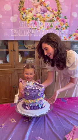 A post by @laurenpaley on TikTok caption: All she wanted this year was “a cake to blow the candles out” and she was SO happy! Our girl is 3 🥹🫶🏻 #disney #birthdaygirl #tangled #rapunzel #cake #disneyprincess 