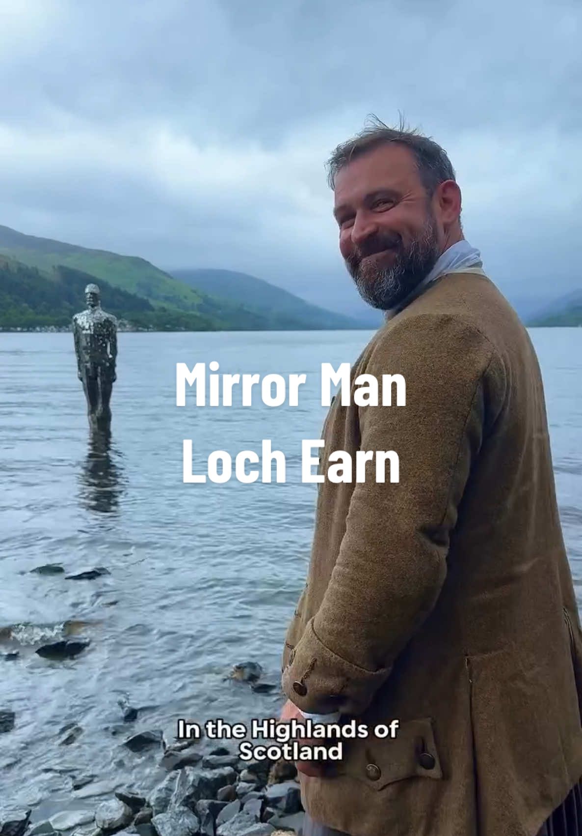 A post by @andy_highlander on TikTok caption: Meet Mirror Man, a silent figure standing waist-deep in Loch Earn.  Officially titled “Still” and created by artist Rob Mulholland, he reflects the landscape, the weather, and anyone who stops to look twice. Set against the ever-changing skies of the Highlands,he somehow feels right at home here. Strange, beautiful, and just a little eerie. #lochearn #mirrorman #highlands #andythehighlander #visitscotland #scotland