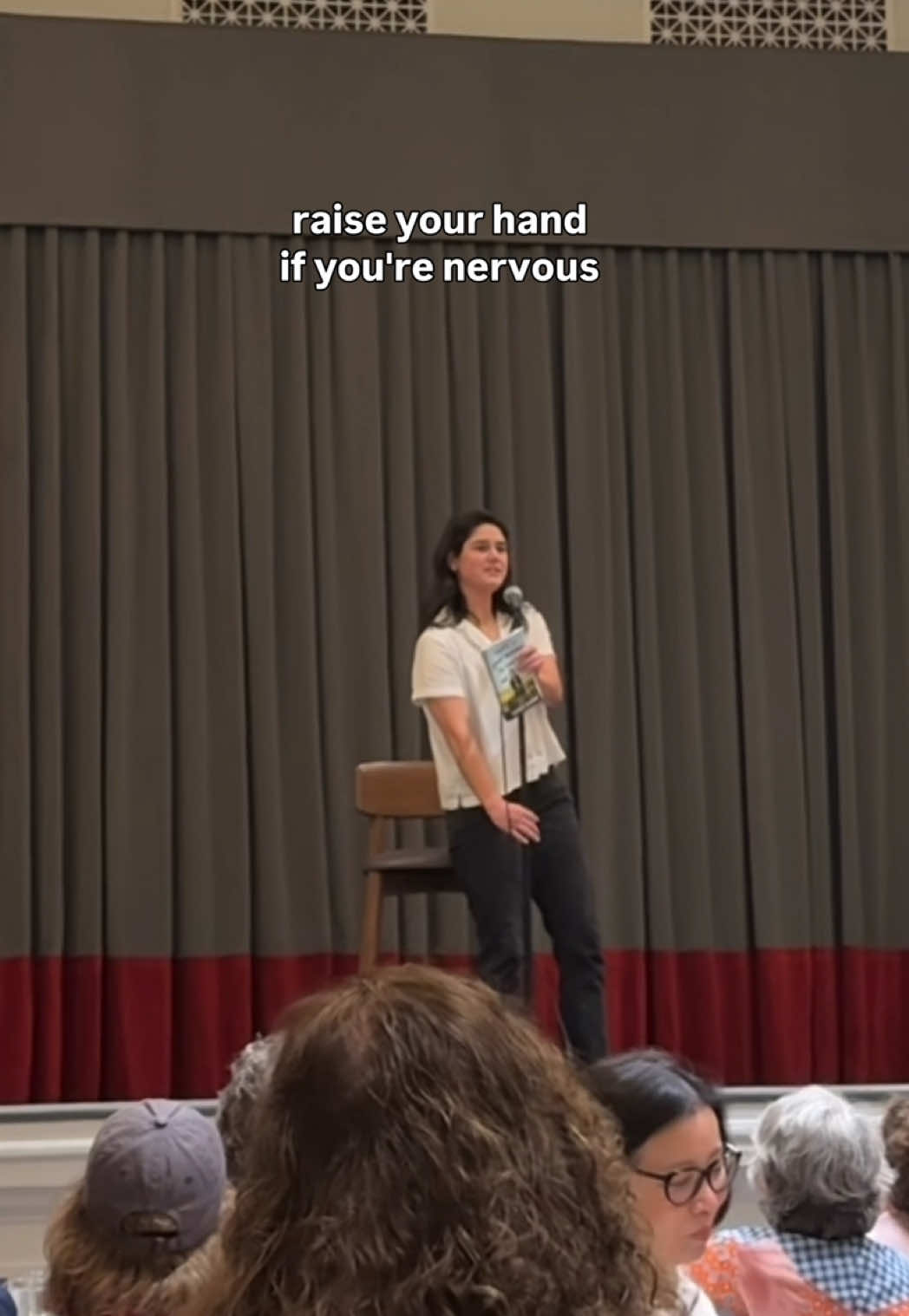 A post by @elysemyers on TikTok caption: this is me realizing in real time that I am so out of my depths and forgot that at some point the world was actually going to read the book I spent 2 years writing and illustrating. 😂 of all the rooms I could have read an excerpt to from my book for the very first time, a room full of 250 librarians was THE room to do it in. (pre-order That’s a Great Question, I’d Love to Tell You!) 📚
