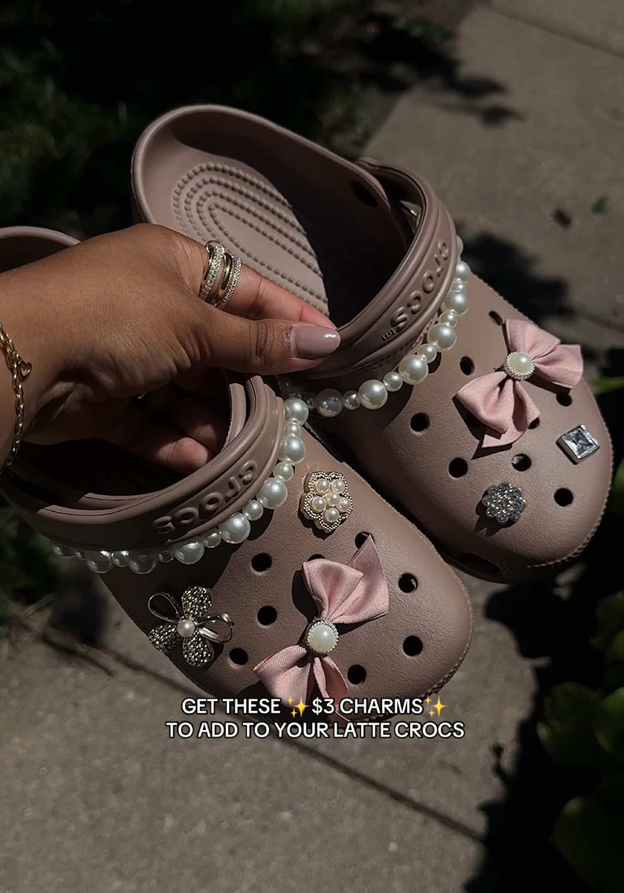 A post by @bettyyannhill on TikTok caption: The cutest way to elevate your crocs 🤎👏🏽✨ #crocs #crocsclogs #crocsclassicclogs #crocslatte #lattecrocs #shoecharms #charmsforshoes #shoebling #blingforshoes #summersandals #tiktokshopcreatorpicks #dealsforyoudays 