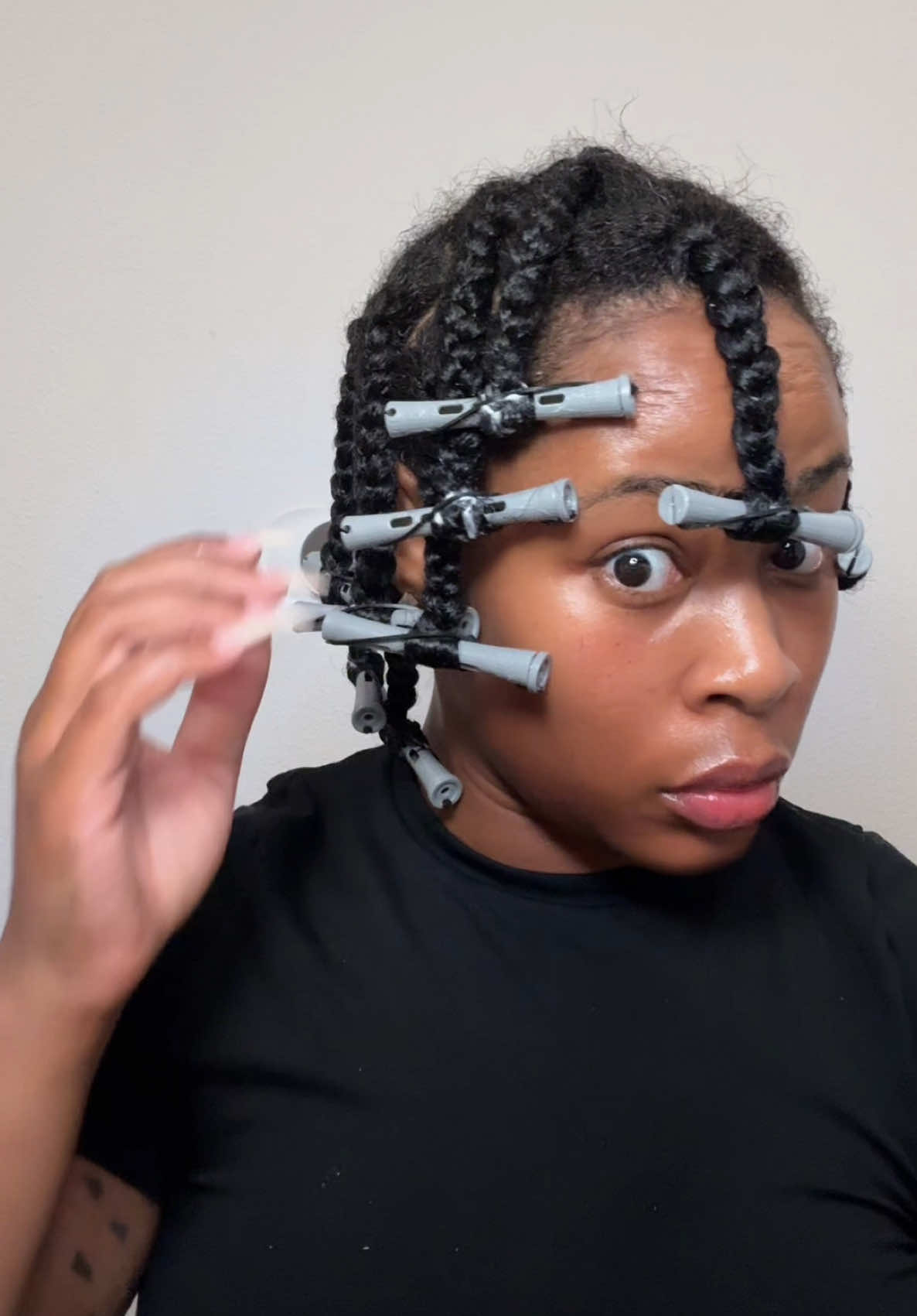 A post by @ on TikTok caption: Braid out tutorial on wet natural hair. This is my first time trying the technique but I got the hang of it fast. Amika product are amazing the hydrate is next level. My hair feels hydrated and bouncy #braidout #naturalhair #heatlesscurls #protectivestyles #blackhair 