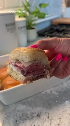 A post by @britscookin on TikTok caption: These sliders are perfect for your 4th of July spread 💙🇺🇸—easy, cheesy, and full of flavor thanks to @Daisy Brand French Onion Dip! I love using Daisy Dips because they’re made with clean ingredients and this one has that creamy, caramelized onion flavor without any extra work!    French Onion Roast Beef Sliders   Ingredients: • 12 slider buns • 1 lb deli-style roast beef • Daisy French Onion Dip • 12-16 slices provolone cheese • 4 tbsp butter, melted • 1 tsp minced garlic • Garlic salt, to taste • ½ tsp dried parsley • Optional: au jus for dipping   Instructions: 1. Preheat oven to 350°F. 2. Slice buns in half and place the bottoms in a baking dish. 3. Add a layer of provolone, then a generous spread of Daisy French Onion Dip. 4. Pile on the roast beef, then another layer of cheese. 5. Place the top buns back on. 6. Mix melted butter with garlic, garlic salt, and parsley. Brush it over the tops. 7. Cover with foil and bake for 20 minutes, or until the cheese is melty and the roast beef is heated through.  • Note: Cooking time may vary depending on how cold or thick your roast beef is. 8. Serve warm with extra Daisy Dip or au jus on the side!   #sliders #4thofjulyfood #easyrecipes #comfortfood #frenchonion #DaisyPartner  