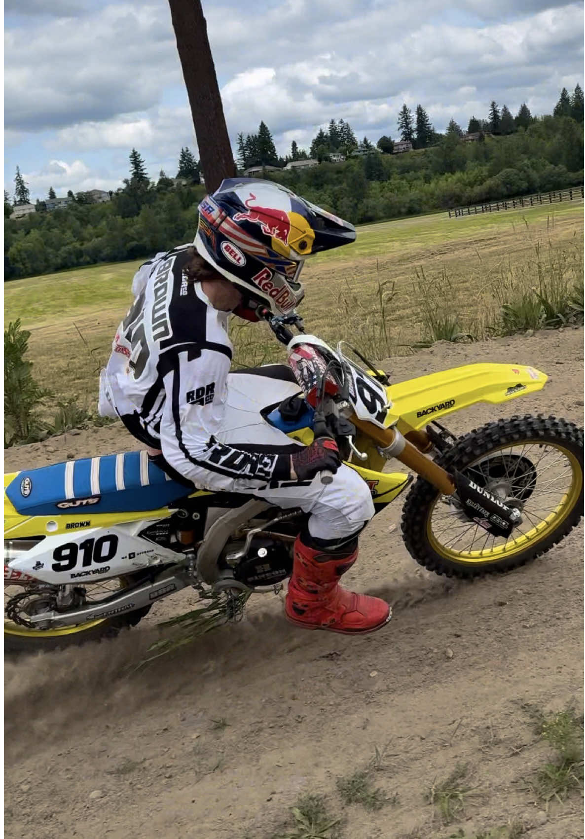 A post by @carsonbrown_910 on TikTok caption: What bike would you guys choose to rip around this track? Letting the MotoSport Hillsboro RMZ450 bark while I get loose at The Kelley Farm 🤠 @Red Bull Motorsports @Red Bull @All Balls Racing @MotoSport.com 🎥: @Charlie McDermott Hale #RMZ450 #suzuki 