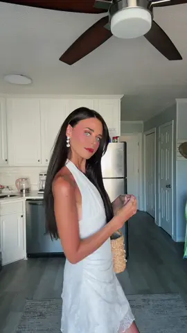A post by @lydiahickman on TikTok caption: A tan with white dress combo is always the correct choice ☀️🌊🐚