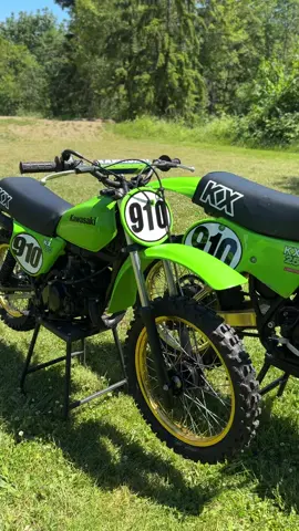 A post by @carsonbrown_910 on TikTok caption: Are you guys firing up the 1979 KX80 or KX250 first? @Red Bull Motorsports @Red Bull @MotoSport.com @All Balls Racing #KX250 #kawasaki #2stroke 