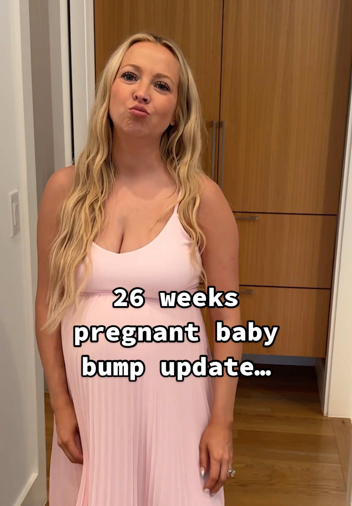 A post by @kayandtayofficial on TikTok caption: Her bump at the end! 😳❤️ backstory ::: Kay is 26 weeks pregnant today, and is feeling bug so much! Bug has been growing and is over 2lbs now! It’s crazy that we still have so much longer in this pregnancy because it’s already felt like she’s been pregnant for most of the year! I am so excited to meet bug! She’s going to be so precious! 🥹 Kay is so beautiful and always looks amazing. She was trying on dresses for her baby shower. And I think this was beautiful, but she has a couple more to try! I can’t wait to see what else she has! #kayandtayofficial #couples #pregnant #postpartum 