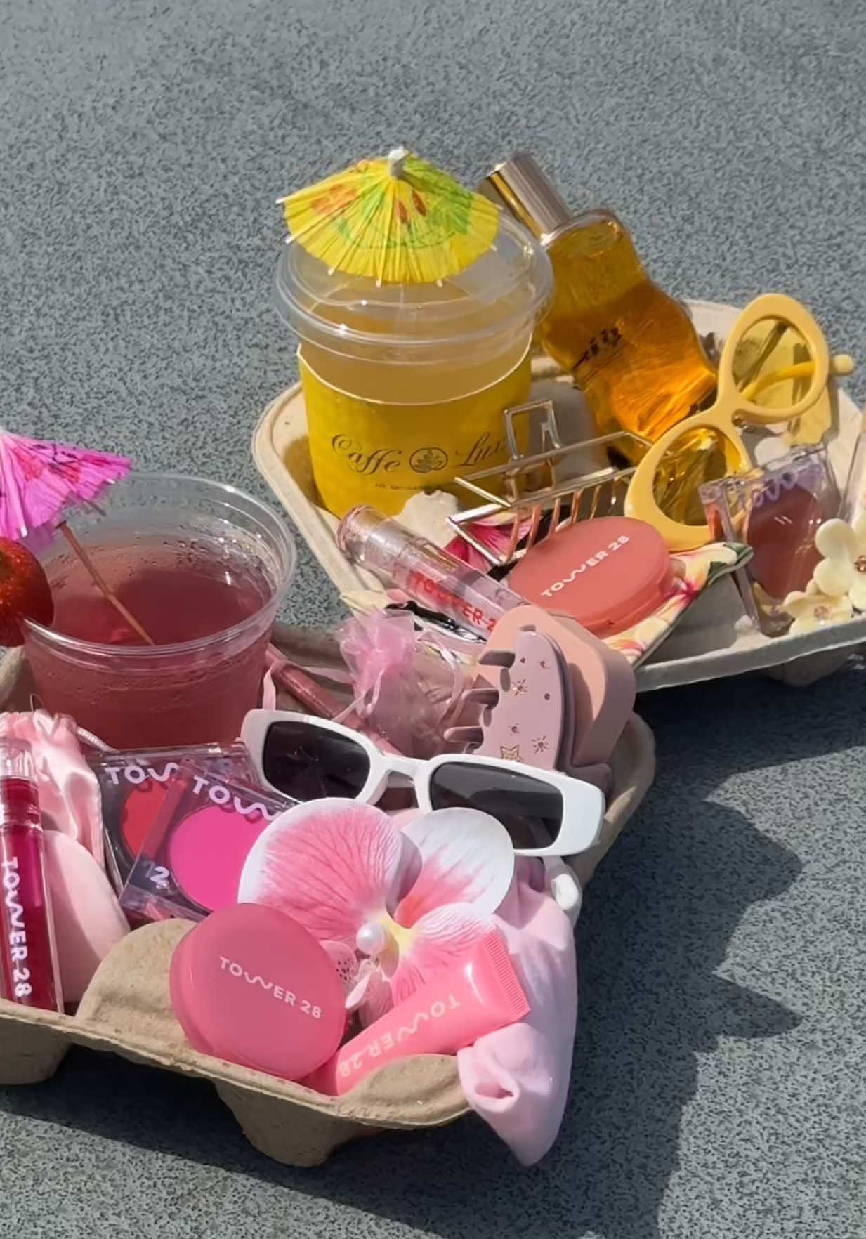 A post by @tower28beauty on TikTok caption: On today’s episode of Tower 28 summer…. ☀️👙🍊✨🫶 #coffeetray #twobestfriends #tower28 #tower28beauty 