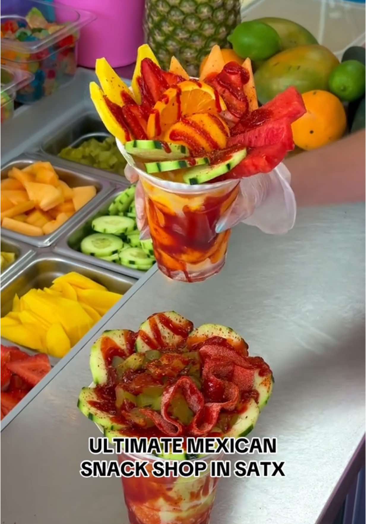 A post by @sanantoniofoodie on TikTok caption: ✨ VIRAL MEXICAN SNACK SHOP IN SATX ✨ @Ice Ice Baby San Antonio is an amazing family-owned snack shop in San Antonio, serving up all your favorite Mexican treats like mangonadas, raspas, elotes, chamoy pickle cups, giant fruit cups, smoothies, the viral RUSA drink, fruit roll-up pickles, and Sandía Paletas – perfect for summer! 🌽🍉🥒🥭🍓🥤 📍 2113 Bandera Rd 📍 3027 MacArthur View #mangonada #fruitcup #mexicansnacks #mexicansnackshop #thingstodoinsanantonio #satx #sanantoniofood #sanantoniofoodie #sanantoniotx #sanantoniotexas #210 