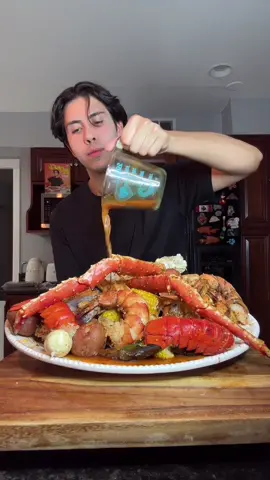 A post by @benjixavier on TikTok caption: A lighter seafood boil that still brings BIG flavor 🦐🔥🍋 This recipe is fully customizable .. I used crab, lobster, shrimp, and mussels, but you can swap in whatever seafood you love. The best part? The sauce is made from the seafood boil water, so you get all the flavor with way less fat 💪🏼🧄 Here’s what I used ⬇️ Ingredients: 🧂 1 crawfish & seafood boil seasoning pack (I used Zatarain’s) 🍋 4 lemons 🌿 4 bay leaves 🌶️ 2 tsp Cajun seasoning 🧅 1 large white onion 🧄 10 garlic cloves 🌽 4 ears of corn 🥔 5 red potatoes 🦀 2 lbs snow crab legs 👑 1 lb king crab 🦞 2 lobster tails 🟢 2 lbs green mussels 🦐 2 lbs jumbo shrimp 💪🏼 2 monster shrimp Sauce: 🧈 3 heaping tbsp reduced-fat butter 🧄 3 tbsp minced garlic 🧅 ½ white onion, sliced 💧 3 cups seafood boil water (from the pot) 🍋 Juice of 1 lemon 🌶️ 2 tsp Cajun seasoning 🧄 2 tsp garlic powder 🧅 2 tsp onion powder 🌶️ 2 tsp paprika 🍗 2 tsp chicken bouillon 🍋 2 tsp lemon pepper (unsalted) 🔥 2 tsp chili powder 🌿 2 tsp thyme 🌿 2 tsp dried oregano 🌿 2 tsp dried parsley 🧂 2 tsp Old Bay 🧪 1 tsp cornstarch + ¼ cup water (slurry to thicken) How to Make It: 1️⃣ Bring a big pot of water to a boil. Add the seasoning pack, lemons (halved), bay leaves, garlic cloves, and Cajun seasoning. Let it boil a couple minutes. 2️⃣ Add corn and red potatoes. Boil for about 15 minutes or until tender, then remove them and set aside. 3️⃣ Add seafood to the boiling pot in batches: — King crab (6–10 min) — Snow crab (5–7 min) — Lobster tails (5–8 min) — Monster shrimp (4–6 min) — Mussels (3–5 min) — Jumbo shrimp (2–3 min) Once cooked, remove and set aside. Reserve 3 cups of the seafood water for the sauce! 4️⃣ In a skillet, melt butter and sauté garlic and onion. Add lemon juice, seafood water, all the seasonings, and the cornstarch slurry. Simmer until slightly thickened. 5️⃣ Toss shrimp in the sauce for 5 minutes, then remove. 6️⃣ Pour sauce over everything and DIG IN 😮‍💨💦 Would you eat this??👇🏼 #SeafoodBoil #HighProteinMeals #LightenedUpComfortFood ##RebelEats #HealthySeafood #CleanIndulgence #healthyrecipes 