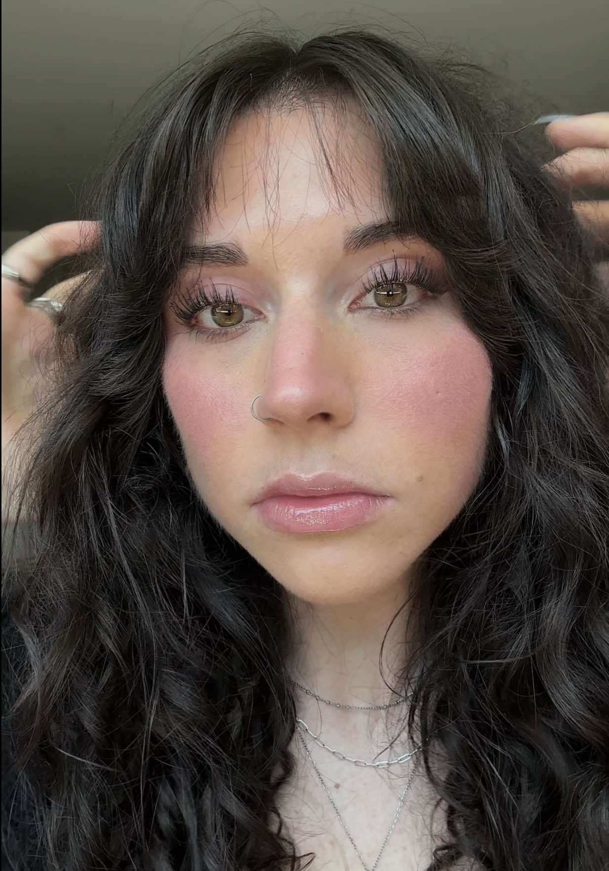 A post by @mariannasreads on TikTok caption: Everyday glowy makeup.  @MERIT Beauty foundation stick @Kosas brow pop nano  @Natasha Denona concealer  @Saie sun melt (light bronze), dew blush (shade chilly), and setting powder  @Nudestix nudies glow highlighter blush (I dew) @Rare Beauty liquid highlighter (enlighten) @Charlotte Tilbury setting spray  @L’Oréal Paris telescopic mascara  @revlon color stay eyeliner  #grwm #makeuptutorial #makeup #glowymakeup