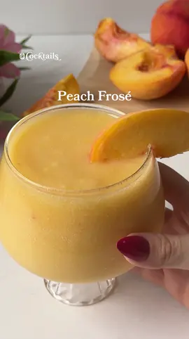 A post by @cocktails on TikTok caption: Sip back and relax with this Peach Frosé.🍑 -1 cup frozen peaches -1.5 rosé wine #peachfrose #frose #peach #frozen #frozencocktails #summer