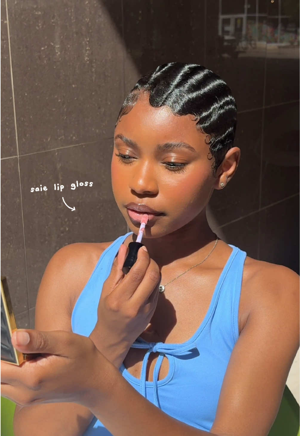A post by @jasorjas on TikTok caption: Serving face, letting the sun do the rest ✨ lip combo: @Fenty Beauty + @Saie 💋 #makeup #lipcombo #fingerwaves #pixie #BeautyTok #blackgirlhairstyles 