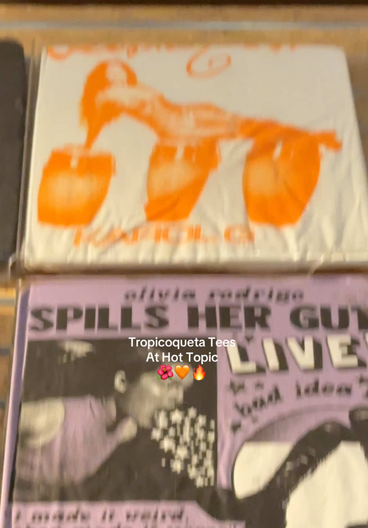 A post by @nanzie_peachez on TikTok caption: Even if it says they don’t have it online they might in store @hottopicofficial @Karol G  #tropicoqueta #karolghottopic #hottopic #karolgtees 
