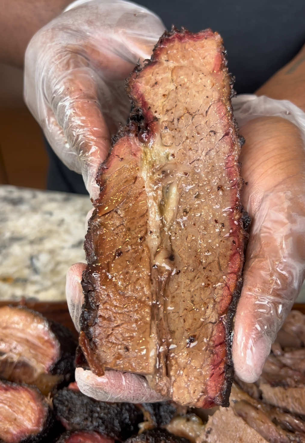 A post by @eatwitzo on TikTok caption: Slow smoked brisket! Welcome back to part three of the weber grills smoker series where we take down one of the more intimidating meats to bbq.  I promise its easy and mostly hands-off to make, especially with @Weber Grills Searwood. #webergrills #woodpellet