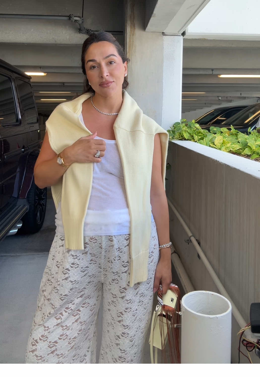 A post by @dzaslavsky on TikTok caption: Pizza night look wearing a tank from @ZARA / lace trousers @DISSH / pullover @Parke / Hermes Chypre shoes & Mini Kelly #ootd #pregnancyfashion #37weekspregnant 