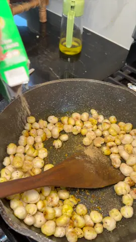 A post by @parmskitchen on TikTok caption: Phul Makane = 😍😍  So easy to make!!  How to: Phul Makhane (Roast until light golden brown)   Cool them off   Add oil to a pan and throw in Salt, Black Pepper, Pink salt, Haldi   Once they’re conjoined, mix in the Phul Makhane.    Don’t forget to add in some Love!    Enjoy 😘