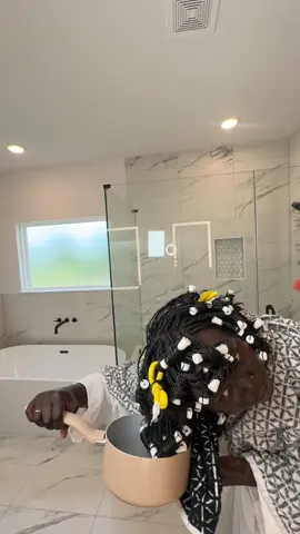 A post by @dollievision on TikTok caption: Curling my synthetic hair in broiling hot water the old days !  Do you like the curls ? #curls #nyadollie #fyp 