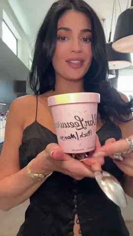 A post by @kyliejenner on TikTok caption: Safe to say there’s no notes. We’ve teamed up with Van Leeuwen to celebrate the launch of our new peach mango lip butter! Our limited edition custom peach mango sorbet will be available exclusively at the Tribeca store in New York City this Thursday July 10 only. The perfect flavor for summer. The first 200 customers will also get a free peach mango lip butter.
