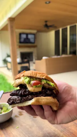 A post by @tylergrowthlife on TikTok caption: Queso and guac burgers on the back patio #vlog #DayInTheLife #outdoorcooking #cookingvlog #fyp #lifestylevlog #blackstone #backpatio #smashburgers 