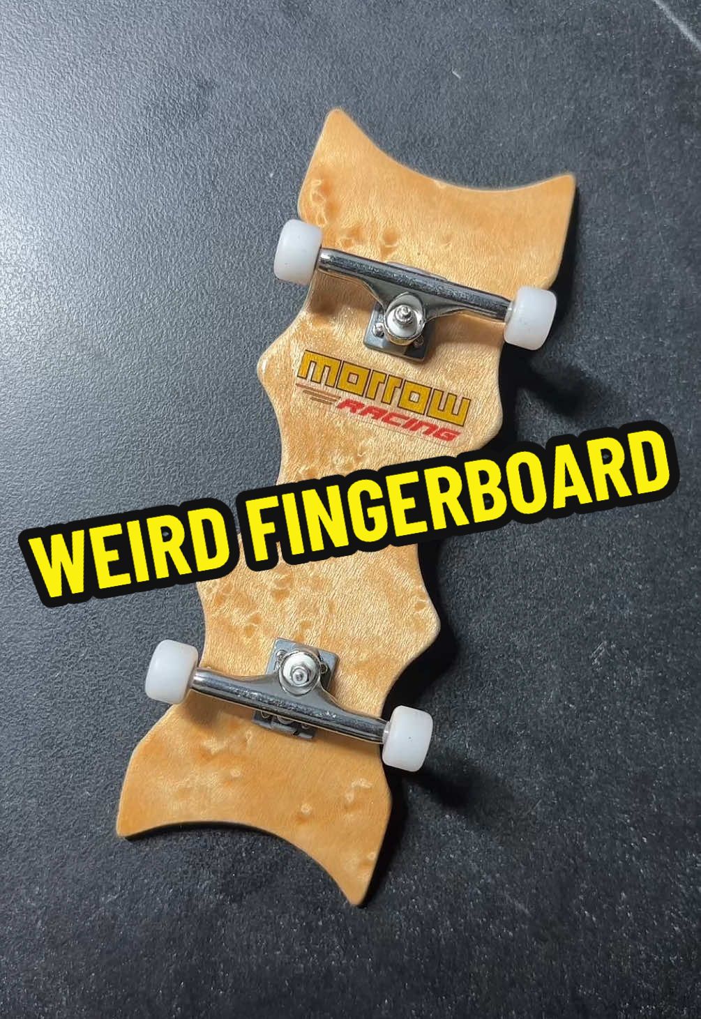 A post by @triplemelon8 on TikTok caption: What’s the weirdest fingerboard you ever ever seen? #morrowdecks #morrowracing #crazyfingerboard #weirdfingerboard #fingerboardshapes #morrowfb
