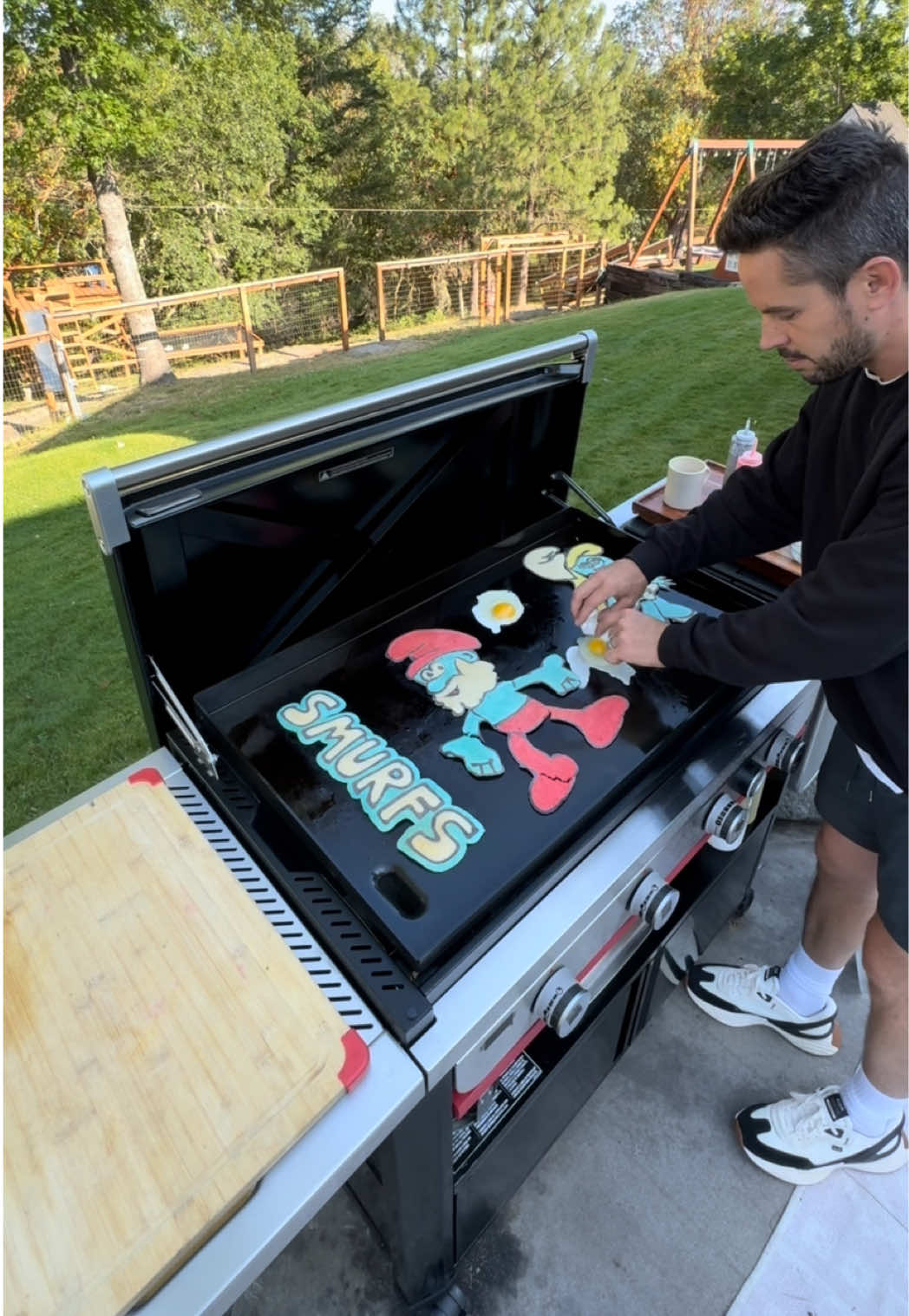 A post by @dadsocial on TikTok caption: From making pancakes on my griddle to promoting the release of my family's favorite movie… This is wild! Go check out @Smurfs Movie in theaters on July 18th with the whole family!! #ParamountPartner #ad