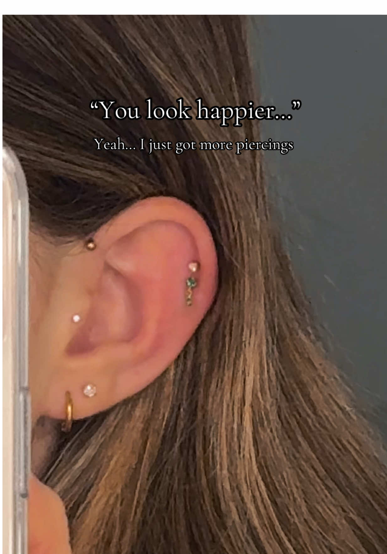 A post by @trisnunemann on TikTok caption: What should I get nextttt #foryou #piercing #helix #conchpiercing #earrings #earringstack #doublehix #tragus 