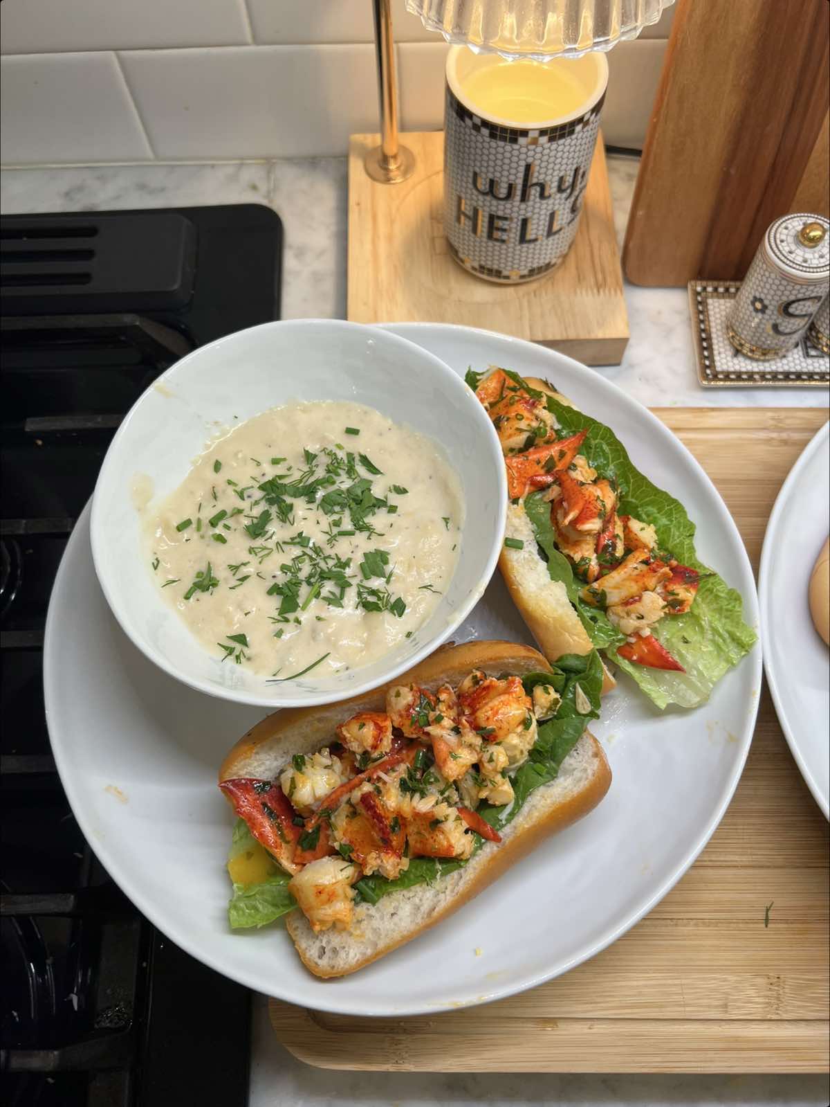 A post by @claudia.harrington on TikTok caption: Tyler really said sit back & relax 🦞 Recipe will be live tomorrow🩵 #glutenfree #lobsterrolls #lobsterroll #clamchowder #newenglandsummer #newenglandrecipe #newenglandclamchowder #warmlobsterrolls #dinneridea 