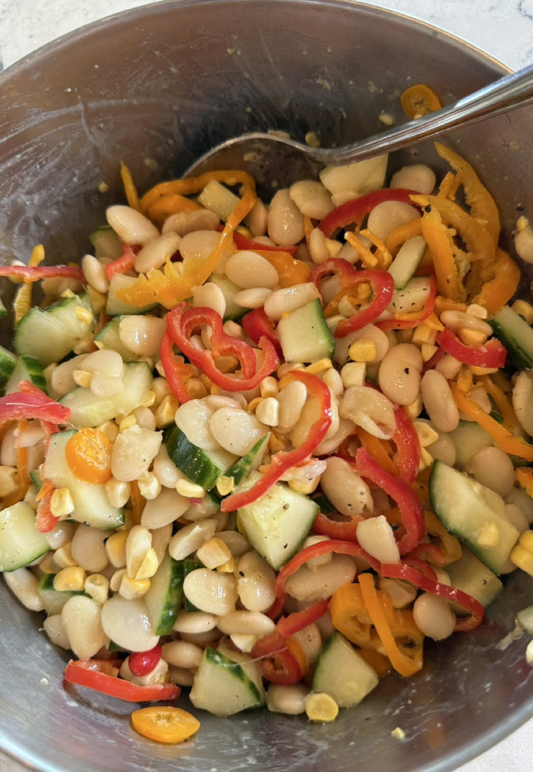 A post by @brialem on TikTok caption: chicken thighs & orange honey dijon bean salad 💃🏼