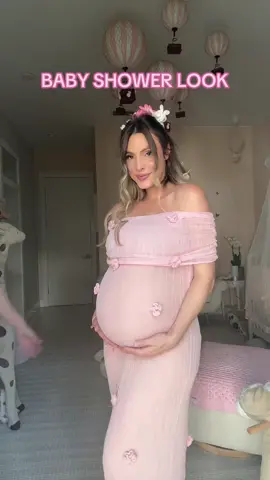 A post by @ on TikTok caption: My mom threw me a private family baby shower. 🩷🥹 (just woman) Dress: @Meshki 