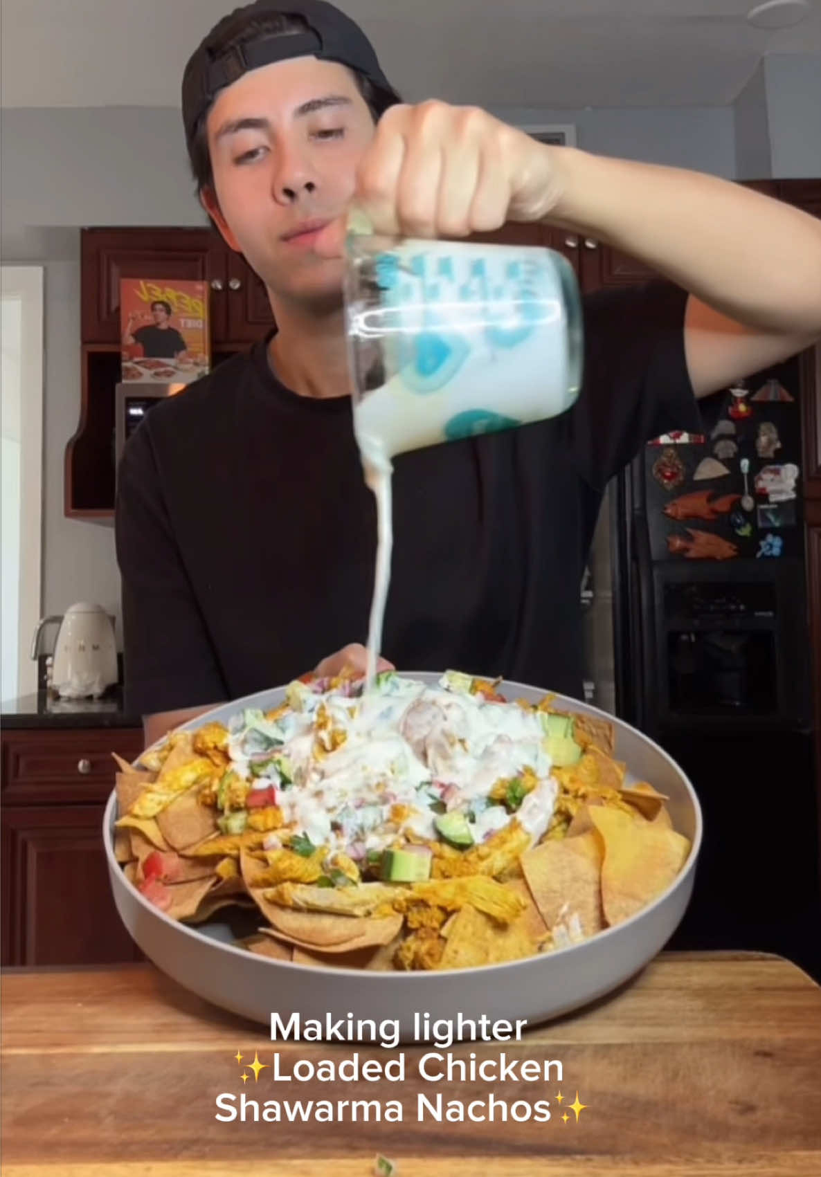 A post by @benjixavier on TikTok caption: LIGHTER, HIGH PROTEIN LOADED CHICKEN SHAWARMA NACHOS 🔥🍗🧄🧅 If shawarma and nachos had a protein-packed baby… THIS would be it. Layers of bold, spiced chicken, crispy tortilla chips, refreshing cucumber salad, and creamy garlic white sauce. It’s giving flavor bomb 💣💥 Perfect for meal prep, parties, or when you wanna feel like a rebel with your food choices 😈 INGREDIENTS 📝 Chicken: 🍗 2 lbs Chicken thigh 🧅 2 tsp Onion powder 🧄 2 tsp Garlic powder 🌰 1 tsp Cinnamon 🌿 1 tsp Cumin ✨ 2 tsp Turmeric 🌱 2 tsp Coriander 🧂 1 tsp Salt ⚫ 1/2 tsp Black pepper 🌶 2 tsp Paprika 🔥 1 tsp Red chili flakes 🥣 1 tsp Chicken bouillon 🥛 2 heaping tbsp non-fat Greek yogurt 🍋 Juice of 1 lemon 👉🏼 I only used HALF of the cooked chicken (1 lb) for the nachos and saved the rest for shawarma wraps & bowls later in the week. Tortilla Chips: 🌽 24 low-calorie corn tortillas (Mission yellow corn) 🫒 Olive oil spray Cucumber Salad: 🥒 1 large cucumber, diced 🍅 2 Roma tomatoes, diced 🧅 1/4 red onion, diced 🌿 1/4 cup parsley, minced 🍋 1/2 lemon, juiced 🧂 Salt to taste White Sauce: 🥛 3/4 cup plain yogurt 🍋 1/2 lemon, juiced 🧄 1 tbsp garlic (minced or paste) 🥣 1 tsp chicken bouillon 🧂 Salt to taste QUICK INSTRUCTIONS ⏱️ 1️⃣ Season & Cook Chicken: Toss chicken with spices, Greek yogurt & lemon juice. Marinate 15+ min - 2 hours, then bake at 375 for about 45 min or until the internal temp has reached 165F or sear until cooked. 2️⃣ Make Chips: Cut tortillas into triangles, spray with olive oil, and bake at 375F for 10-14 mins or air-fry at 400°F for 6–10 min until crispy. 3️⃣ Cucumber Salad: Mix cucumber, tomato, red onion, parsley, lemon juice & salt. Chill. 4️⃣ White Sauce: Whisk all sauce ingredients until smooth. 5️⃣ Assemble Nachos: Layer chips ➡️ chopped cooked chicken ➡️ cucumber salad ➡️ drizzle with white sauce. 🔥 Optional: Top with extra parsley, feta, or chili flakes! 💪 Macros (based on 1 lb chicken used, 5 servings): Calories: 432 Protein: 40g Carbs: 44.8g Fat: 16g 🎥 Watch til the end to see how I layer this masterpiece… and don’t skip that sauce drizzle 😮‍💨 #ShawarmaNachos #HighProteinRecipe #MealPrepIdeas #RebelEats #BenjiXavier #benjixavierr #HealthyComfortFood #TheRebelDiet #weightlossrecipes #healthyrecipes #shawarma