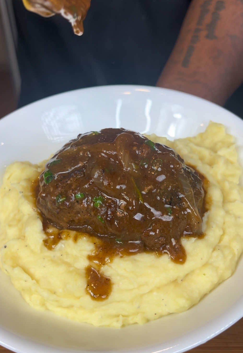 A post by @eatwitzo on TikTok caption: Homemade Salisbury Steak  You either loved or hated Salisbury steak growing up, to me it’s comfort food! Enjoy!  Full Ingredient list:  For salisbury steak:  1-2 lb ground beef or ground turkey 1-2 eggs  3-4 dashes Worcestershire sauce  1- 1 1/2 cup beef broth  1/4 cup bread crumbs  2-3 tsp garlic powder  2-3 tsp onion powder  2-3 tsp black pepper 2-3 tsp dried oregano  2-3 tsp salt (optional)  Rosemary sprig  1 medium onion sliced  Cornstarch slurry (2 tbsp cornstarch + 1 tbsp water)  For mashed potatoes:  5-6 medium yukon gold potatoes  1-2 tbsp chicken bouillon powder (in water)  1-2 tbsp garlic paste  1/2 stick butter  1/4-1/2 cup sour cream  1/4 cup heavy cream  Salt & pepper to taste #salisburysteak #eatwitzo 