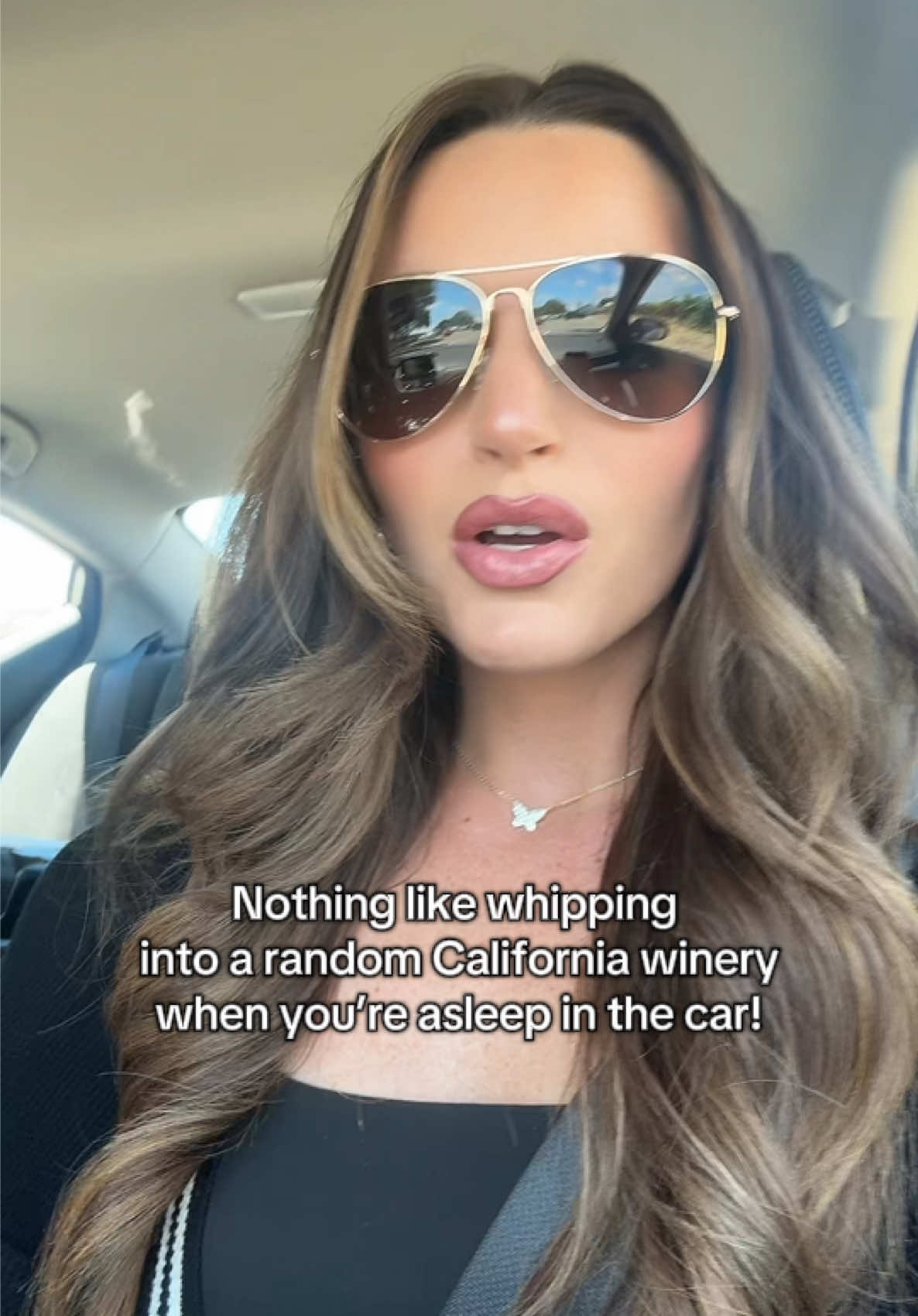 A post by @carolineontv on TikTok caption: The plan was to check into our hotel, but here we are sippin’ away! 🍷 #winetiktok🍷 #wine #california 