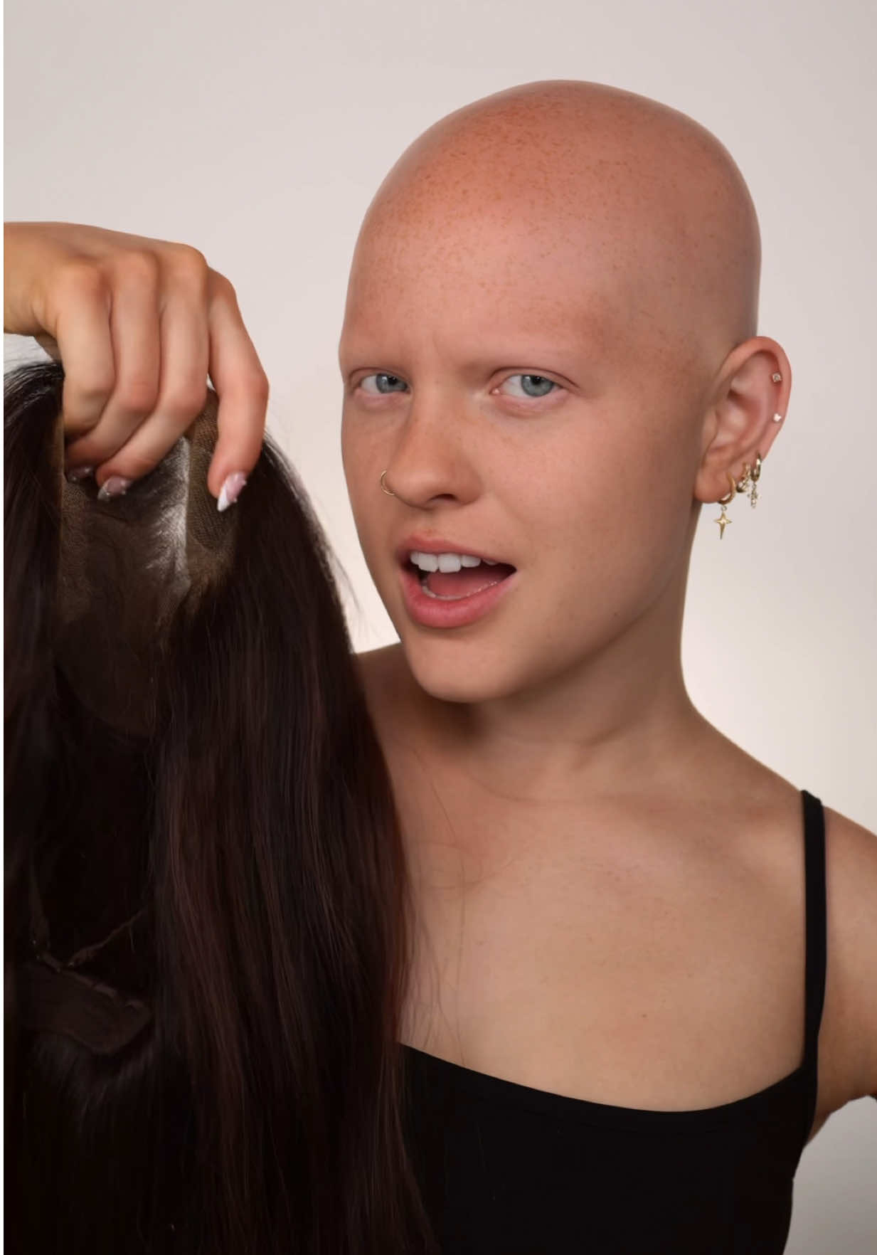 A post by @ on TikTok caption: Oh yeah, by the way I felt like being a brunette today 🫡🤪  This wig is from @M O R A M O D E  #alopecia #wigs #makeup 