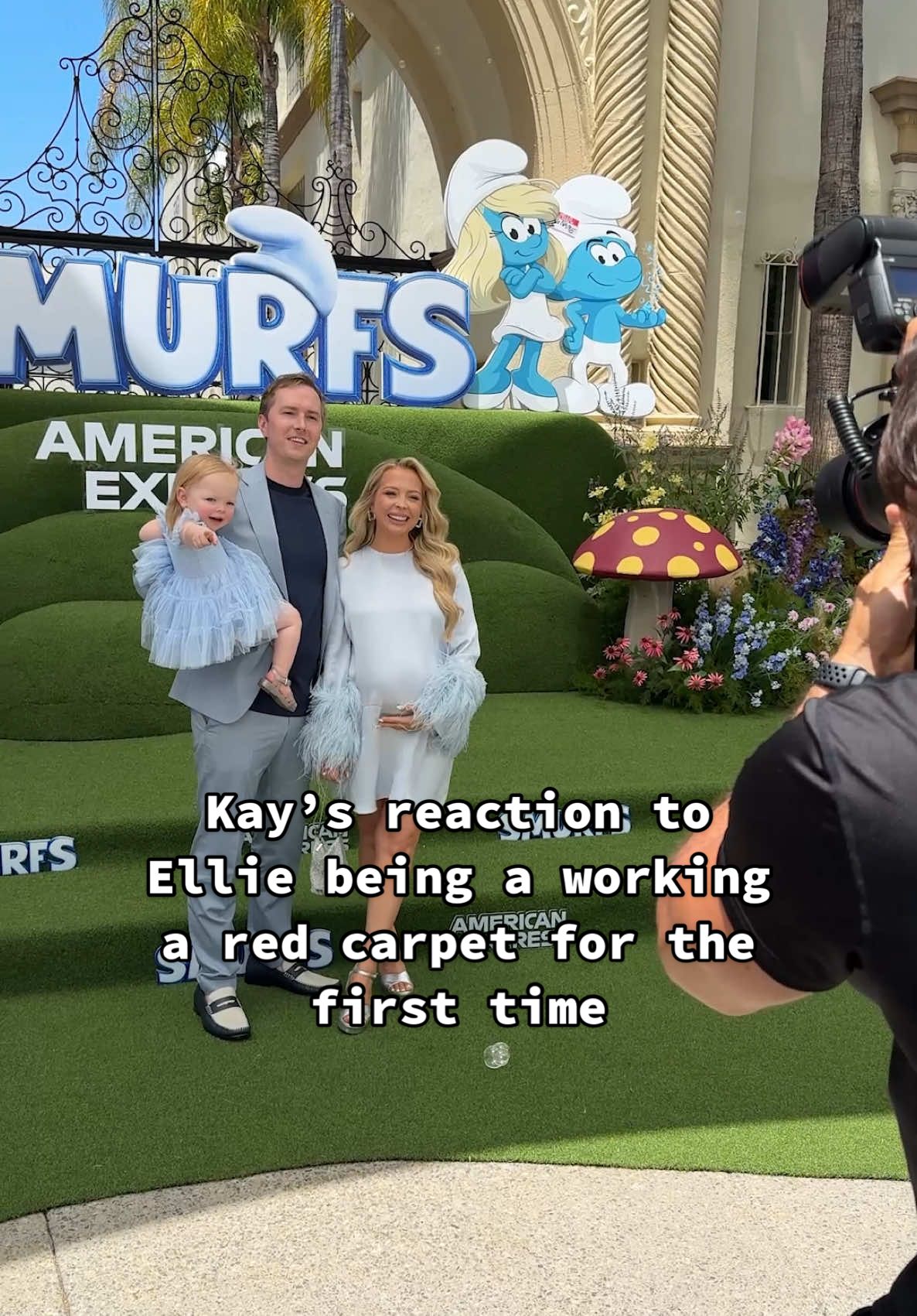 A post by @kayandtayofficial on TikTok caption: Ellie was such a brave baby on the red (blue) carpet! 🥹🩵 backstory ::: Kay and I were sent by Paramount to the Smurfs premiere, and it was Ellie’s first time walking the red carpet! We picked her out a pretty blue dress to match the Smurfs and let her sleep right up until it was time for us to walk it! 😂 She was so confused when she woke up, because when she fell asleep we were in the car, and when she woke up, we were in a Smurf village! 🤣 When she got up, we put her cute purse on and shortly after it was time to walk the carpet! Ellie happily strolled down and did amazing having her pictures taken! 🥹 She looked so pretty and it was so fun to see her get to walk a carpet for the first time! 🥹 Afterwards, we had some snacks and Ellie had a little dance party in the lobby before the movie! When the movie started, it was so cute, and Ellie was clapping along with all of the songs! 😂🩵 I can’t wait for her next red carpet! Because it’s so cute seeing her be a little star! ⭐️ #kayandtayofficial #couples #relationships #pregnant #postpartum